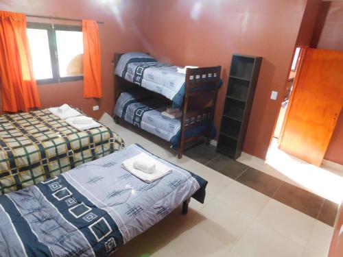 a room with two beds and a bed sidx sidx sidx at Hospedaje Sol de Reyes Jujuy in Reyes