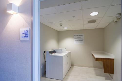 a clinic waiting room with a washer and dryer at Holiday Inn Express Hotel & Suites Tampa-USF-Busch Gardens by IHG in Tampa