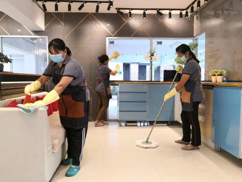 a group of people with masks and mop in a kitchen at Gems Park Don Mueang Airport and BTS in Bangkok