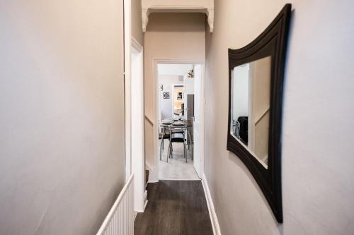 a hallway with a mirror and a dining room at 4 Bedroom House- Close to City Centre- Ideal for Contractors- Free Parking- Sleeps 8 in Stoke on Trent