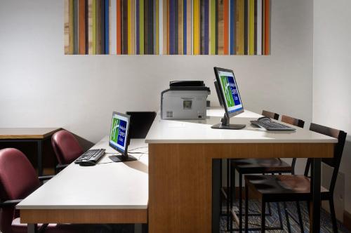 two computers sitting on a desk in an office at Holiday Inn Express & Suites Charlottesville - Ruckersville by IHG in Ruckersville