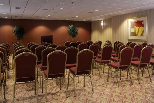 a row of chairs in a room with a podium at Holiday Inn Express & Suites Charlottesville - Ruckersville by IHG in Ruckersville