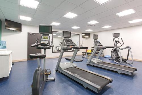 a gym with treadmills and elliptical machines at Holiday Inn Express & Suites Lincoln I - 80 by IHG in Lincoln