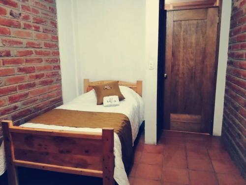 Postel nebo postele na pokoji v ubytování Lagoon Hotel Chugchilan
