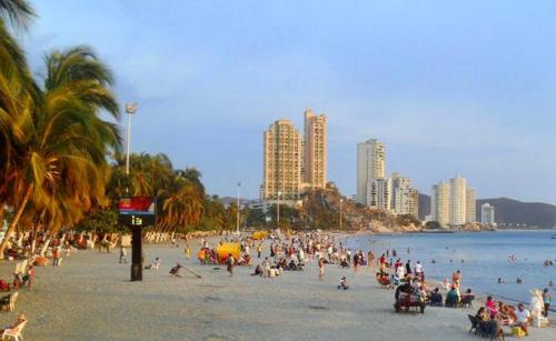 a large group of people on a beach at Edificio Maratea Apt 704 El Rodadero in Santa Marta