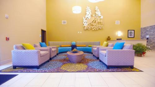 a waiting room with couches and a rug at Holiday Inn Express Hotels & Suites Cuero by IHG in Cuero