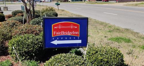 a sign for a farmiologist express on the side of a road at FairBridge Inn Express Stuttgart in Stuttgart