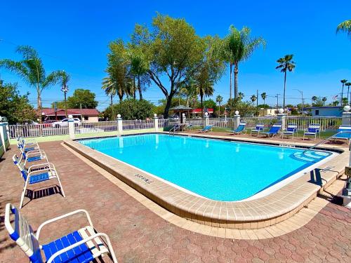 a swimming pool with lounge chairs around it at Gulf Way Inn Clearwater in Clearwater