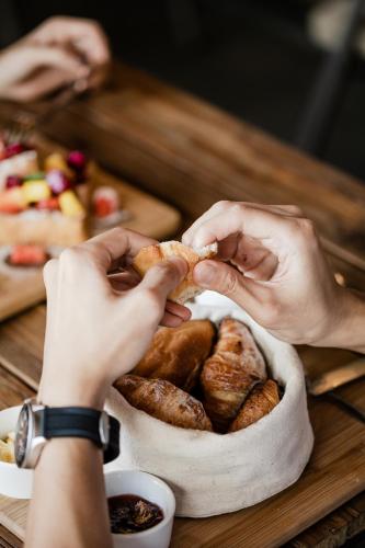 a person holding a piece of bread in a bowl of food at Wasabi in Canggu