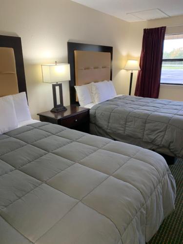 a hotel room with two beds and a window at Blackwater Inn Milton in Milton