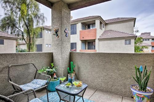 a patio with a table and chairs on a wall at Modern Condo with Pool Access about 3 Mi to Dtwn Phoenix in Phoenix