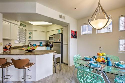 a kitchen with a counter and a table with chairs at Modern Condo with Pool Access about 3 Mi to Dtwn Phoenix in Phoenix
