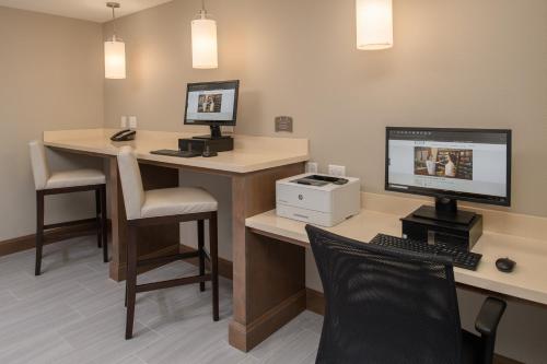 an office with a desk with a computer and a chair at Staybridge Suites - Hillsboro North by IHG in Hillsboro