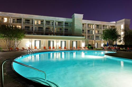 a large pool in front of a hotel at night at Holiday Inn & Suites Atlanta Airport North by IHG in Atlanta