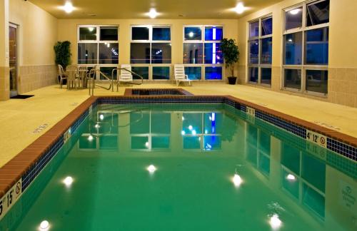 a swimming pool with green water in a house at Holiday Inn Express Hotel & Suites Shamrock North, an IHG Hotel in Shamrock