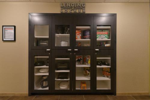 a black cabinet with glass doors in a room at Candlewood Suites Casper, an IHG Hotel in Casper