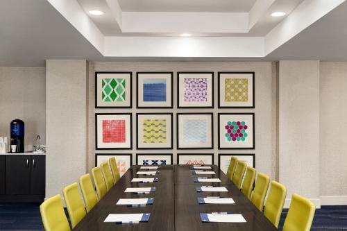 a conference room with a long table and yellow chairs at Holiday Inn Express Hotel & Suites Shawnee I-40 by IHG in Shawnee