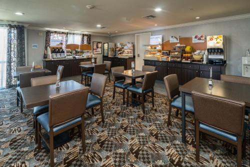 a restaurant with tables and chairs and a counter at Holiday Inn Express & Suites Santa Clara by IHG in Santa Clara