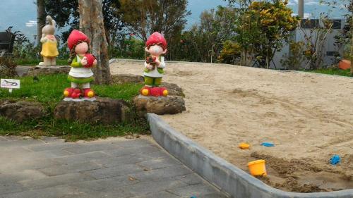 a group of toy figurines sitting in the sand at Khokak Panoramas Hotel in Gukeng