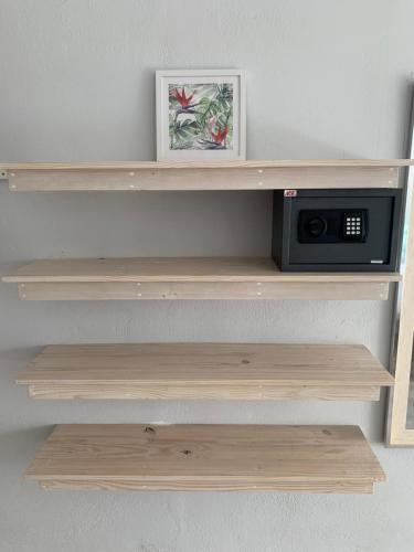 a wooden shelf with a microwave on it at Crown Malapascua in Malapascua Island