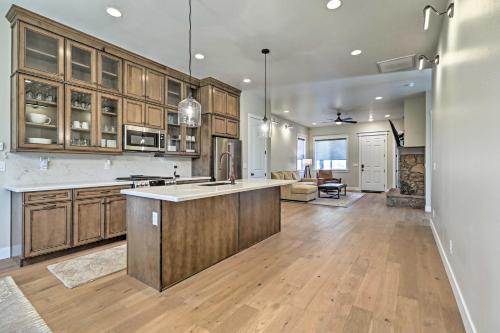 a kitchen with wooden cabinets and a kitchen island at Flagstaff Oasis with Hot Tub - 3 Mi to Downtown! in Flagstaff