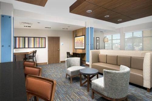 a living room with a couch and chairs and a table at Holiday Inn Express & Suites San Antonio North-Windcrest by IHG in San Antonio
