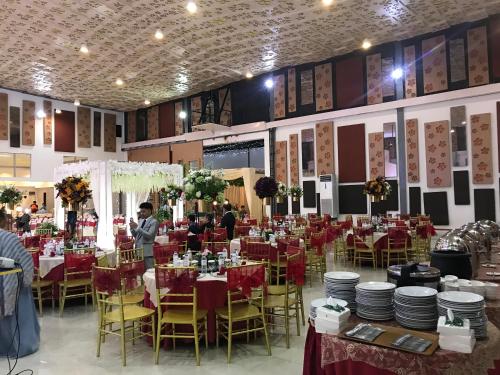 a banquet hall with red tables and chairs at Sinar Sport Hotel in Bengkulu