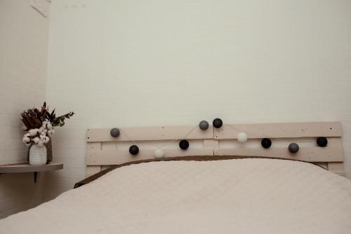 a bed with a wooden headboard with spheres on it at Apartments at Kontorska 10 in Kharkiv