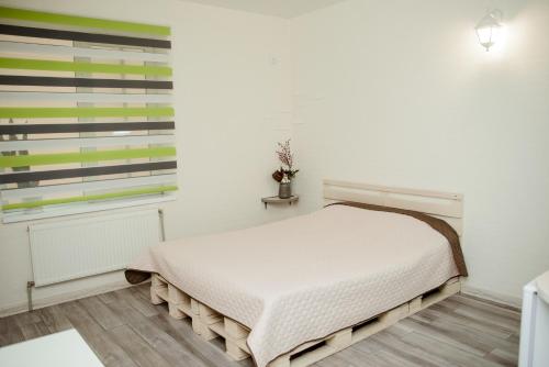 a white bedroom with a bed and a window at Apartments at Kontorska 10 in Kharkiv