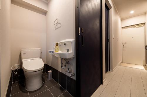 a bathroom with a toilet and a sink at PORTO7-5 in Chatan