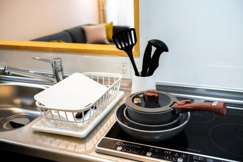 a kitchen counter with a drying rack and utensils at PORTO7-5 in Chatan