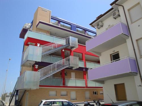 a building with stairs on the side of it at Residence La Nave in Senigallia