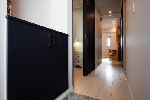 a room with a black door and a hallway at PORTO7-5 in Chatan