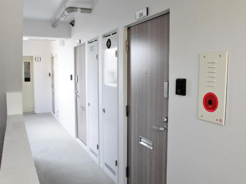 a hallway of a hospital with a red button on the wall at Mango Resort Okinawa Naha in Naha