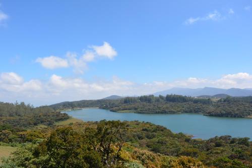 a view of a lake in the hills at Tranquil Villa in Nuwara Eliya