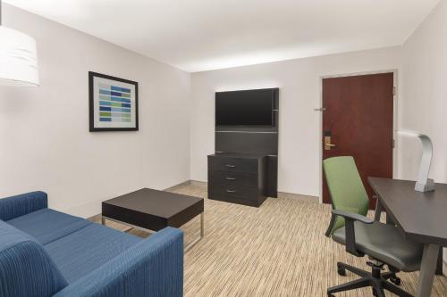 a hotel room with a bed and a desk and a tv at Holiday Inn Express Hotels & Suites Greenville-Spartanburg/Duncan by IHG in Duncan