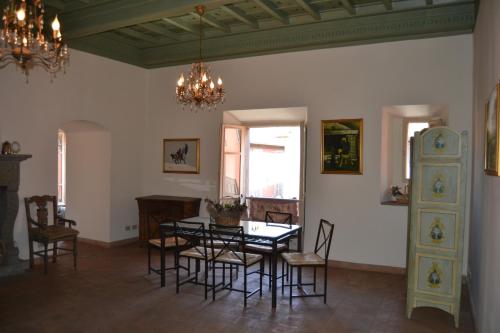 a dining room with a table and chairs and a chandelier at Clockwise in Viterbo
