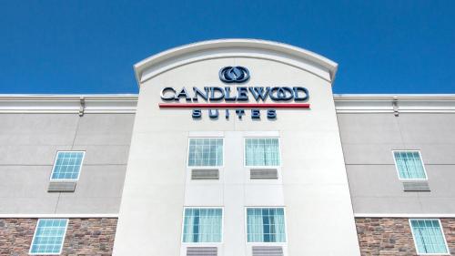a building with a sign on top of it at Candlewood Suites Waco by IHG in Waco