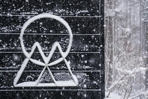 a x sign on a brick wall in the snow at Onpoint Madarao in Myoko