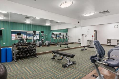 a gym with treadmills and chairs in a room at Holiday Inn Express West Valley City by IHG in West Valley City