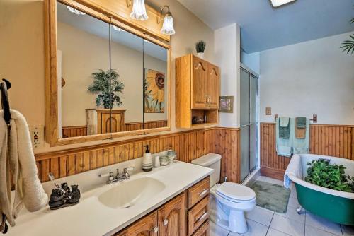 a bathroom with a tub and a sink and a bath tub at Victory Victorian House - Walk to Dtwn Glenwood! in Glenwood Springs