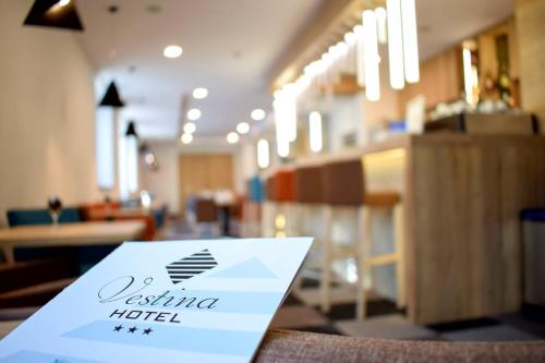 a sign sitting on top of a table in a store at Hotel Vestina in Wisła