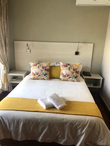 a bedroom with a bed with two towels on it at 314 on Clark Guest House in Pretoria