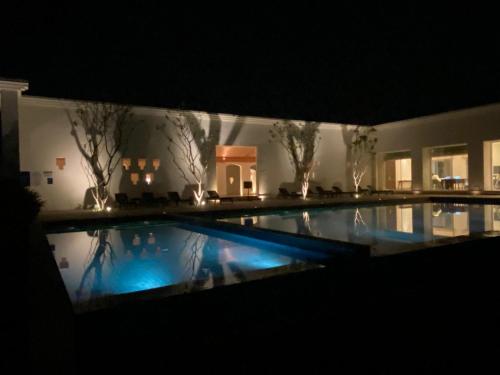 a large swimming pool in a house at night at Marasa Sarovar Premiere, Bodhgaya in Bodh Gaya