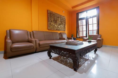 a living room with a couch and a coffee table at Catur Adi Putra in Denpasar