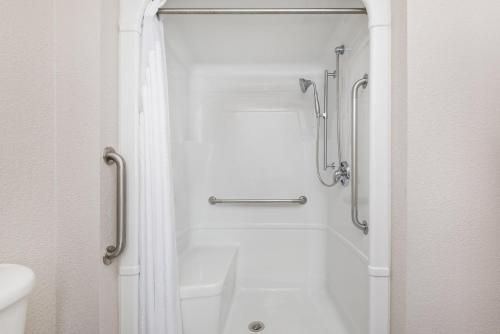a bathroom with a shower and a white tub at Holiday Inn Express Hotel & Suites 1000 Islands - Gananoque, an IHG Hotel in Gananoque