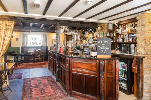 a bar in a pub with a sign on the counter at The Royal Oak in Gillamoor