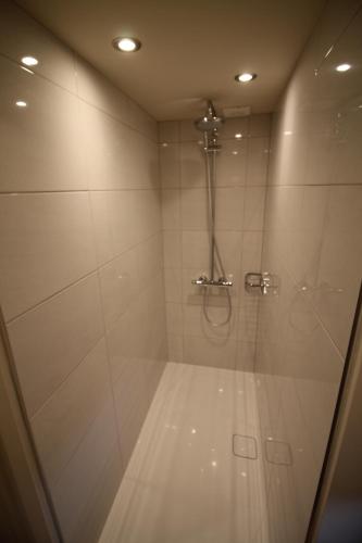 a bathroom with a shower with a glass door at Granny's Attic at Cliff House Farm Holiday Cottages, in Whitby