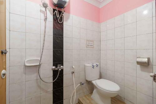 a bathroom with a shower with a toilet in it at RedDoorz Plus @ Jalan Gatot Subroto Medan in Sunggal