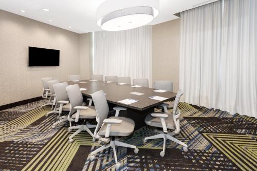 a conference room with a large table and chairs at Holiday Inn Express & Suites Downtown Ottawa East by IHG in Ottawa